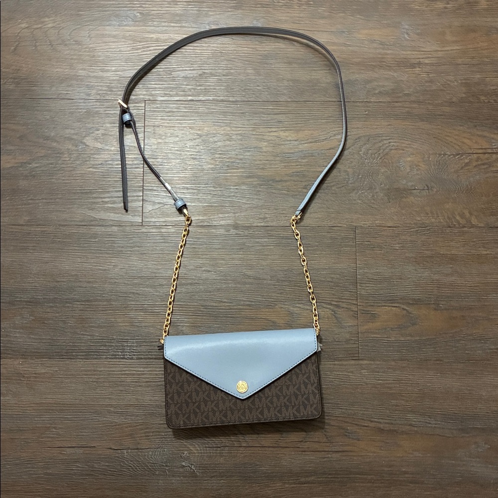 Michael Kors Blue and Brown Jet Set Travel clutch with strap.